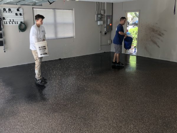 Garage Floor Coating Applying Flakes To Base Coat