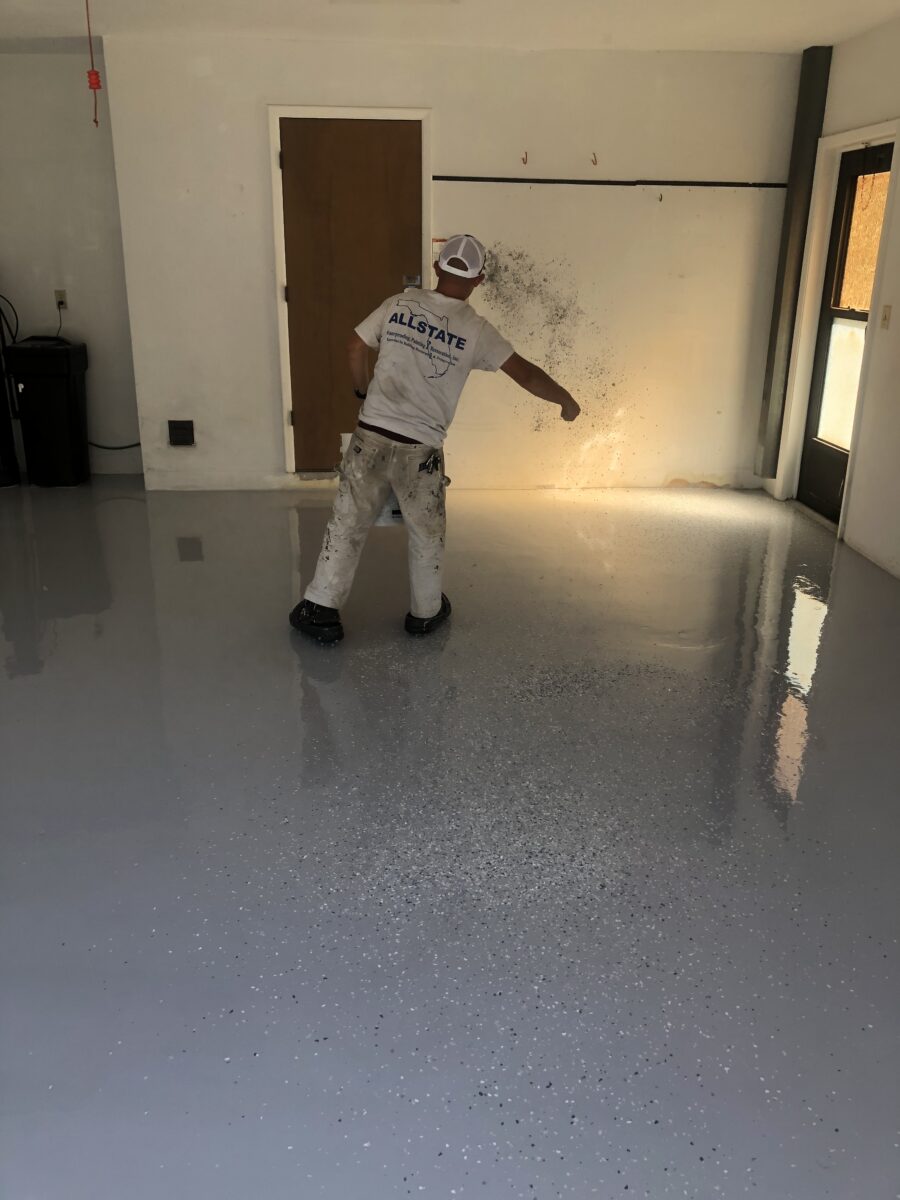 Painter Applying Flake To Custom Garage Floor In Palm Harbor FL