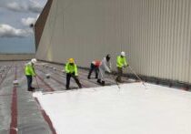 Our crew applying a silicon roof coating on this commercial building in Pasco County.
